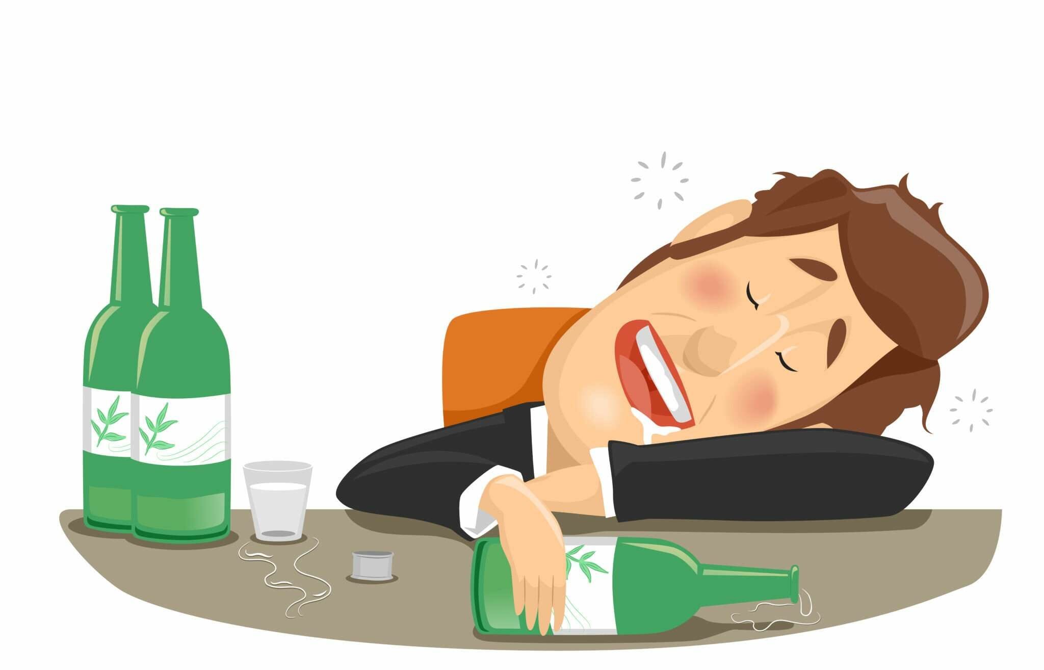 韓国でスーツを着た男性がアルコールのボトルの隣のテーブルで寝ている。