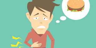 韓国を訪れた際、胃の痛みと胃の中にハンバーガーを抱えた男性。