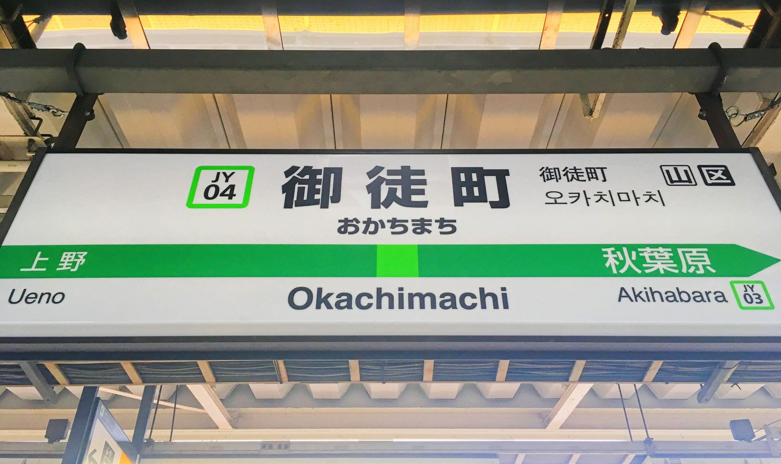 山手線御徒町（JY 04）の駅名標。上野、秋葉原方面を日本語、英語、韓国語で表示。.